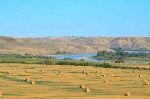 Fall South Saskatchewan River with bales by April